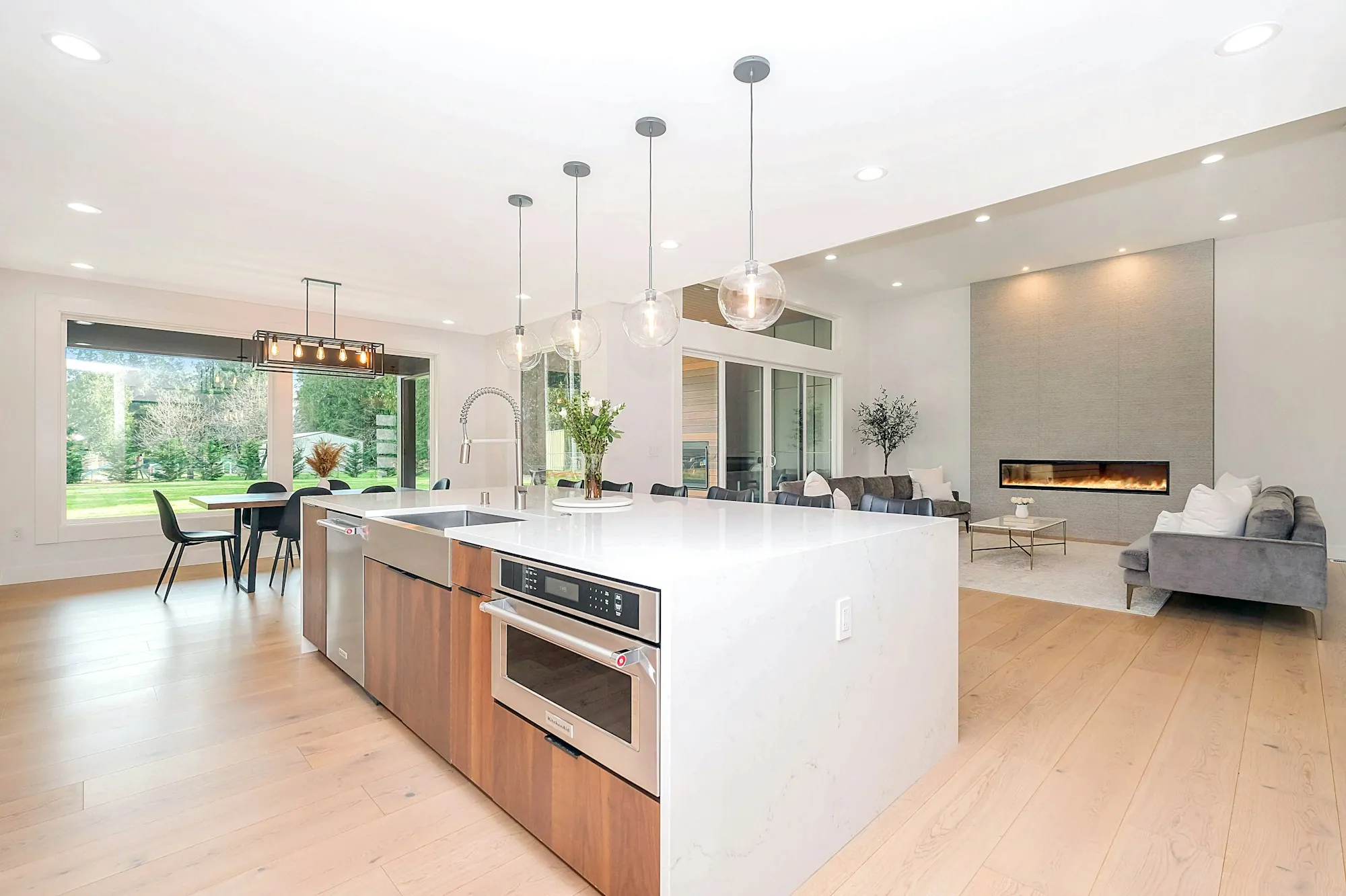 Open kitchen and living area with pendant lights and recessed ceiling lights